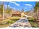 A charming brick home with a well-manicured lawn, mature trees, and a long driveway at 809 Liberty Rd, Gold Hill, NC 28071