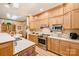 Bright kitchen with wood cabinets, stainless steel appliances, and view into the dining area at 809 Liberty Rd, Gold Hill, NC 28071