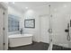 Bright bathroom features a freestanding tub, glass-enclosed shower, subway tile, and black fixtures at 9128 Summer Club Rd, Charlotte, NC 28277