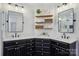 Stylish bathroom with double vanities, black cabinets, white countertops, and decorative mirrors at 9128 Summer Club Rd, Charlotte, NC 28277
