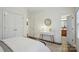 Comfortable bedroom with modern decor, hardwood floors, a desk and a view to the adjoining bathroom at 9128 Summer Club Rd, Charlotte, NC 28277
