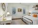 Cozy bedroom with white walls, natural light, wood floors, and simple decor for a relaxing atmosphere at 9128 Summer Club Rd, Charlotte, NC 28277