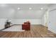 Bonus room features a comfortable orange sofa, a TV, and a door to the bathroom at 9128 Summer Club Rd, Charlotte, NC 28277