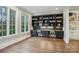 Bonus room featuring hardwood floors, built-in bookshelves, and two windows at 9128 Summer Club Rd, Charlotte, NC 28277