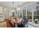 Bright dining room featuring hardwood floors and large windows with an outdoor view at 9128 Summer Club Rd, Charlotte, NC 28277