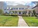 Charming two-story home with well-manicured lawn and symmetrical landscaping at 9128 Summer Club Rd, Charlotte, NC 28277