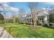 Inviting front yard with lush landscaping, a well-manicured lawn, and a charming front porch at 9128 Summer Club Rd, Charlotte, NC 28277