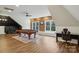 Spacious game room featuring a billiard table, exposed brick, a chalkboard wall, and a work area at 9128 Summer Club Rd, Charlotte, NC 28277