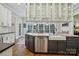 The kitchen features hardwood floors, white cabinets, and a stainless steel dishwasher at 9128 Summer Club Rd, Charlotte, NC 28277