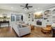 Cozy living room featuring a fireplace, built-in shelving, and large windows at 9128 Summer Club Rd, Charlotte, NC 28277