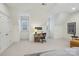 A view of the main bedroom's work area showing its bright white walls and carpeted floor at 9128 Summer Club Rd, Charlotte, NC 28277