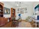 Office with hardwood floors, a large desk, built-in bookcase, and a comfortable armchair at 9128 Summer Club Rd, Charlotte, NC 28277