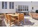 Outdoor dining area with a large wooden table, seating for ten, and a grill nearby at 9128 Summer Club Rd, Charlotte, NC 28277