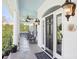 Charming porch with rocking chairs, ceiling fans, and a vibrant blue ceiling at 9128 Summer Club Rd, Charlotte, NC 28277