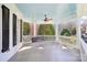 Inviting porch features a swing, ceiling fan, and painted ceiling at 9128 Summer Club Rd, Charlotte, NC 28277