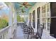 Relaxing front porch with rocking chairs, ceiling fans, and a view of the outdoors at 9128 Summer Club Rd, Charlotte, NC 28277