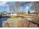 Wide view of fenced backyard with leafless trees, showcasing neighborhood at 922 Grace Ave, Kannapolis, NC 28083