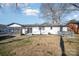 White house exterior showcasing back porch, fenced carport and large yard at 922 Grace Ave, Kannapolis, NC 28083