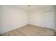 Bright bedroom featuring wood-look flooring, a modern light fixture, and a closet at 922 Grace Ave, Kannapolis, NC 28083