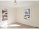 Light-filled bedroom with hardwood floors and views of the yard through two windows at 922 Grace Ave, Kannapolis, NC 28083