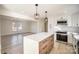 Bright kitchen with white cabinets, stainless steel appliances, and a center island with pendant lighting at 922 Grace Ave, Kannapolis, NC 28083