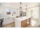 Updated kitchen with white cabinets, stainless appliances, and quartz countertops at 922 Grace Ave, Kannapolis, NC 28083