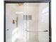 Contemporary shower with vertical white tiles, glass door, and black hardware for a modern spa-like experience at 922 Grace Ave, Kannapolis, NC 28083