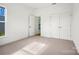 Bright bedroom with plush carpeting, a window, and double closets for ample storage at 9481 Coast Laurel Ave # 12, Concord, NC 28027