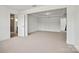 Spacious bonus room with plush carpeting, featuring multiple entryways at 9481 Coast Laurel Ave # 12, Concord, NC 28027