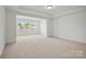 Bonus room offering a bright, open space with windows and neutral decor at 9481 Coast Laurel Ave # 12, Concord, NC 28027