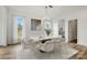 Bright dining room features modern chandelier, marble table and view of the outdoor scenery at 9481 Coast Laurel Ave # 12, Concord, NC 28027
