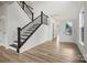 Spacious foyer with a staircase, neutral walls, and light wood floors at 9481 Coast Laurel Ave # 12, Concord, NC 28027