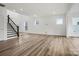 Spacious great room with light wood floors and staircase at 9481 Coast Laurel Ave # 12, Concord, NC 28027