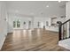 Open-concept great room featuring light wood floors and a well-equipped kitchen at 9481 Coast Laurel Ave # 12, Concord, NC 28027