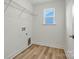Laundry room featuring wood floors, window, and hanging rack at 9481 Coast Laurel Ave # 12, Concord, NC 28027