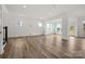 Spacious living room featuring hardwood floors and natural light from multiple windows at 9481 Coast Laurel Ave # 12, Concord, NC 28027