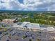 Aerial view of a shopping center, surrounded by trees, residences and a lake, with ample parking and various retail stores at 1001 Mesa Verde Dr, Fort Mill, SC 29707