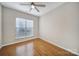 Cozy bedroom featuring hardwood floors, ceiling fan, and window with bright natural light at 1001 Mesa Verde Dr, Fort Mill, SC 29707