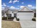 Charming single-story home with a two car garage, manicured lawn, and inviting entryway at 1001 Mesa Verde Dr, Fort Mill, SC 29707