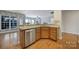 Open kitchen featuring a stainless steel dishwasher, wooden cabinets, and hardwood floors at 1001 Mesa Verde Dr, Fort Mill, SC 29707