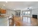 Inviting living room showcasing a fireplace, hardwood floors, and open access to kitchen at 1001 Mesa Verde Dr, Fort Mill, SC 29707