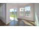 Bright dining space featuring large windows, hardwood floors, and sliding door to the backyard at 109 Ari Ave, Troutman, NC 28166