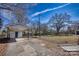 Spacious backyard with a detached garage, a driveway and a blue sky at 111 Courtland St, Chester, SC 29706