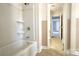 Clean bathroom with a bathtub/shower combination with tile walls and updated fixture at 111 Courtland St, Chester, SC 29706