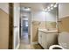 Bathroom featuring vintage tan tile, white vanity with sink, mirror and decorative lighting at 111 Courtland St, Chester, SC 29706