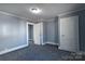 Bedroom featuring light blue walls, white trim, gray carpet, and a closet at 111 Courtland St, Chester, SC 29706