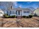 Charming single-story home with blue shutters, manicured bushes, brick chimney, and inviting front entrance at 111 Courtland St, Chester, SC 29706