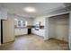 A spacious kitchen with white cabinets, black appliances, neutral walls, and an adjacent storage closet at 111 Courtland St, Chester, SC 29706
