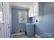 Well-lit laundry room with storage cabinets, and a large window with natural light at 111 Courtland St, Chester, SC 29706