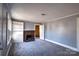 Cozy living room featuring a gray carpet, a fireplace with brick surround, and built-in shelving at 111 Courtland St, Chester, SC 29706